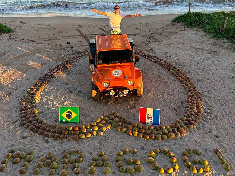 Homem em cima de buggy dentro de coração feito de cocos na Praia de Burgalhau, dica de o que fazer em Maragogi