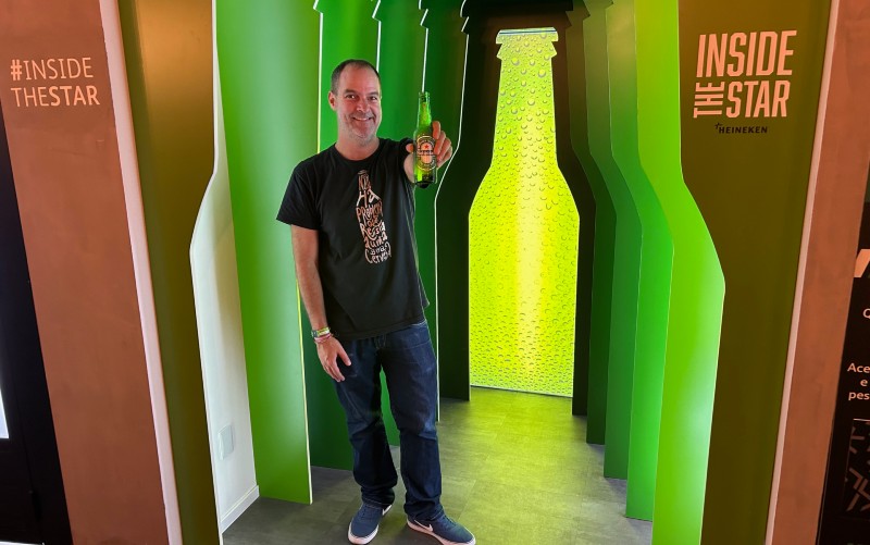 Homem posa com cerveja durante visita à fábrica da Heineken em São Paulo