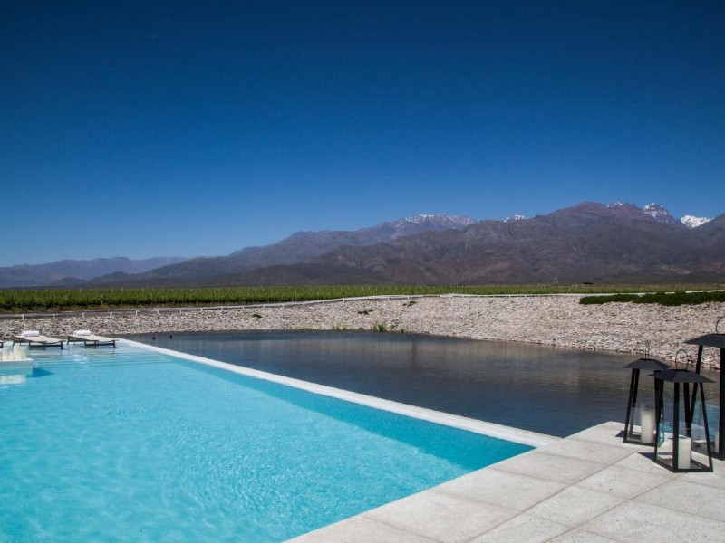 Piscina do Casa de Uco Vineyards & Wine Resort, dica de onde ficar em Mendoza, com montanhas e céu azul